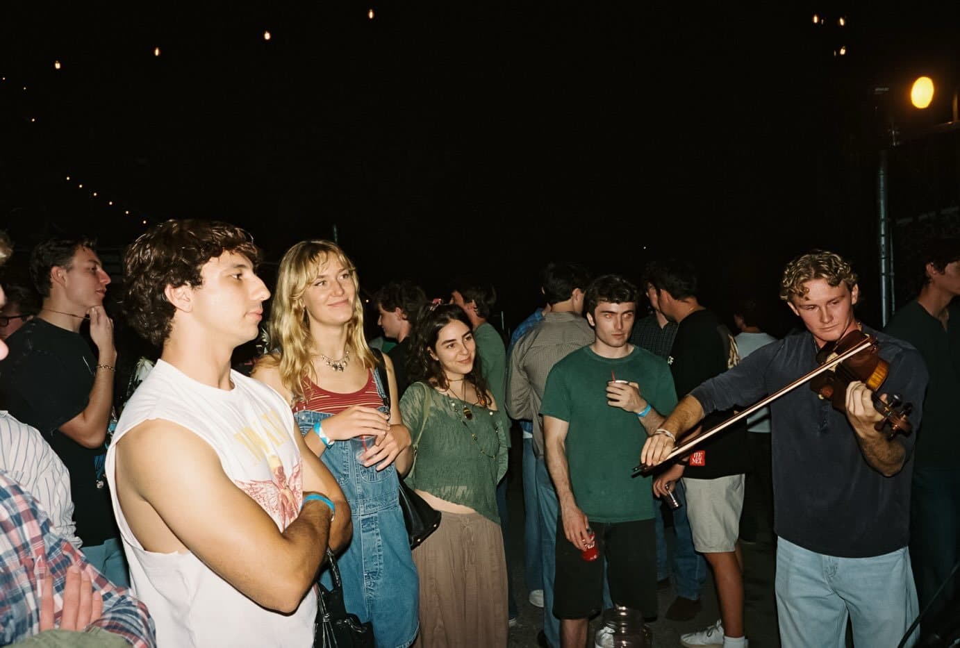 A fiddle player performing in the crowd at the Palm Radio Launch Party