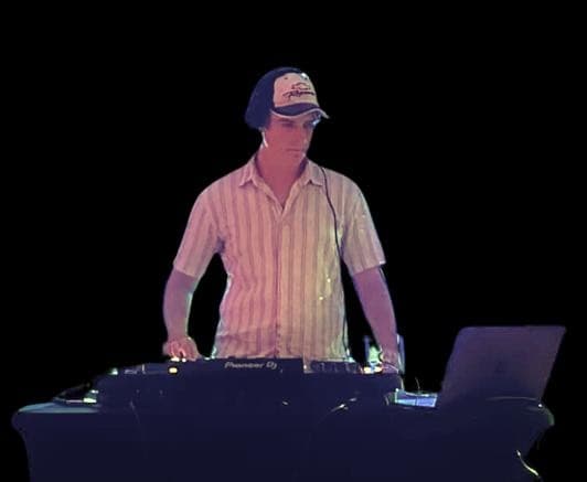 Taylor Young DJing behind the decks